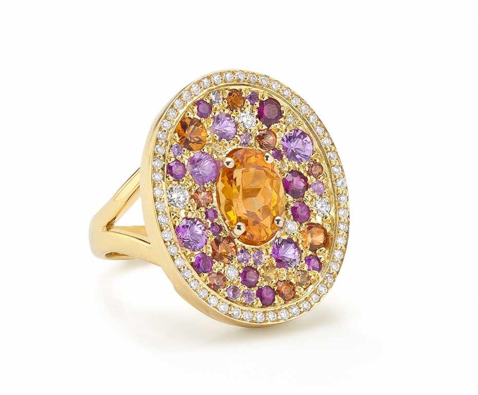 Robinson Pelham white gold Volcano Asteroid ring featuring a central oval mandarin garnet surrounded by a pavé of diamonds, rubies and yellow, orange and pink sapphires.