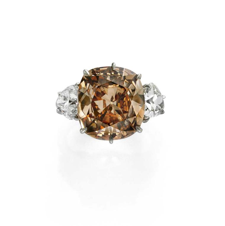 Simon Teakle's 7ct orange-brown diamond ring is flanked by two white diamonds.