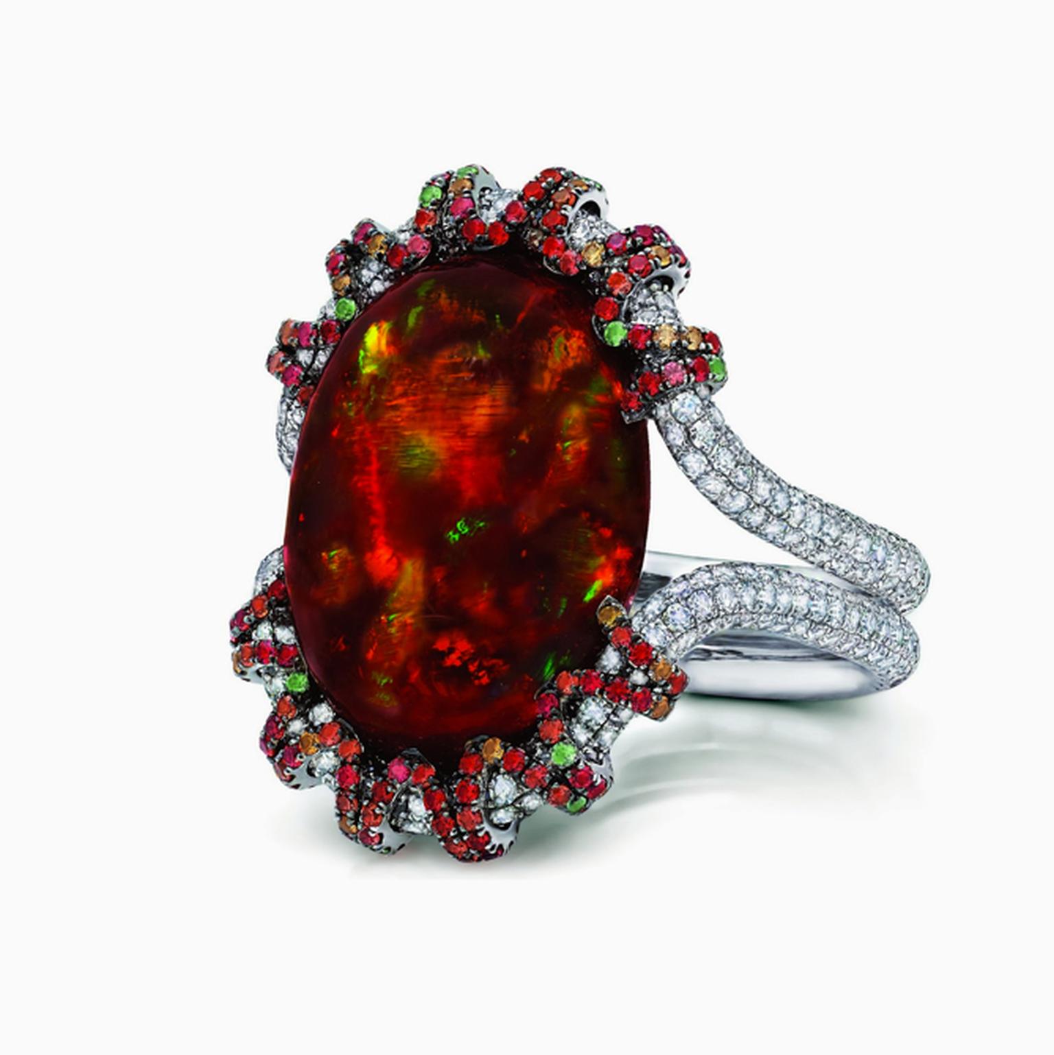 Martin Katz white gold ring featuring a central 13.18ct fire opal cabochon, micro-set with diamonds, tsavorite garnets and orange-red sapphires.