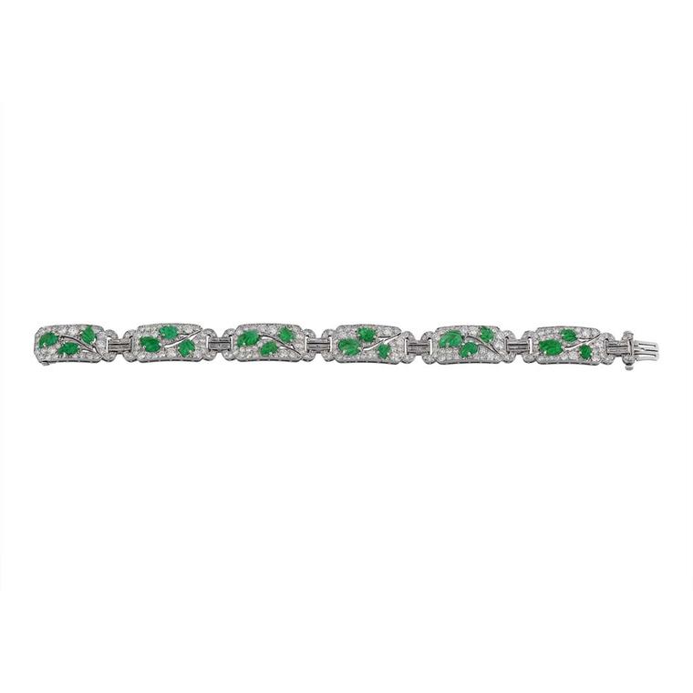 Morelle Davidson vintage Cartier bracelet in platinum with six diamond-pavéd openwork sections, each with three carved emerald leaves forming a branch with baguette diamond-set double links.