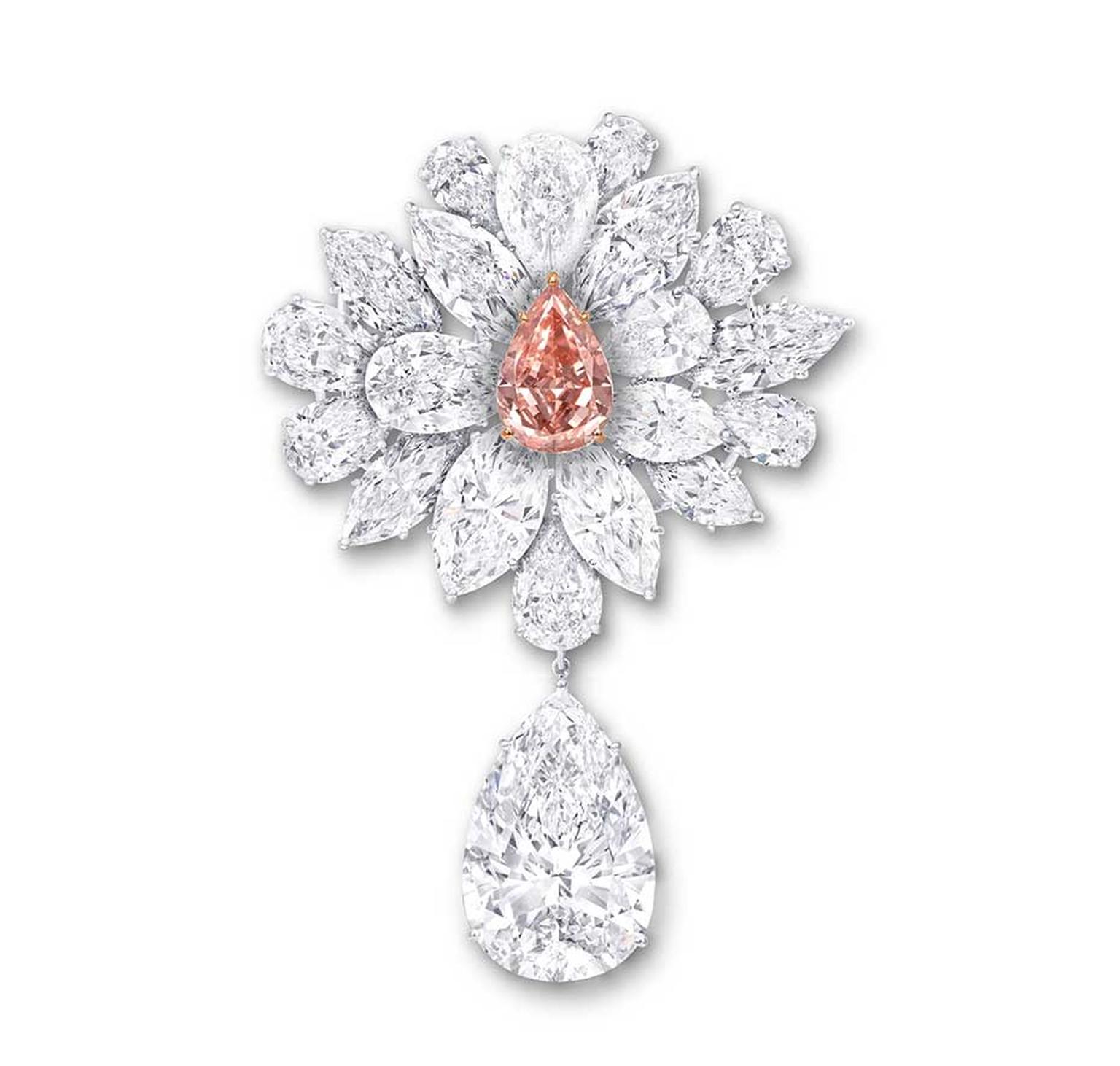 Graff's Diamond Flower Brooch features an 8.97ct pear-shaped Fancy Vivid Pink Orange diamond, surrounded by a spray of white diamond petals and leaves. The brooch is further enhanced with a 38.13ct D Flawless pear-shaped white diamond suspended from a lea