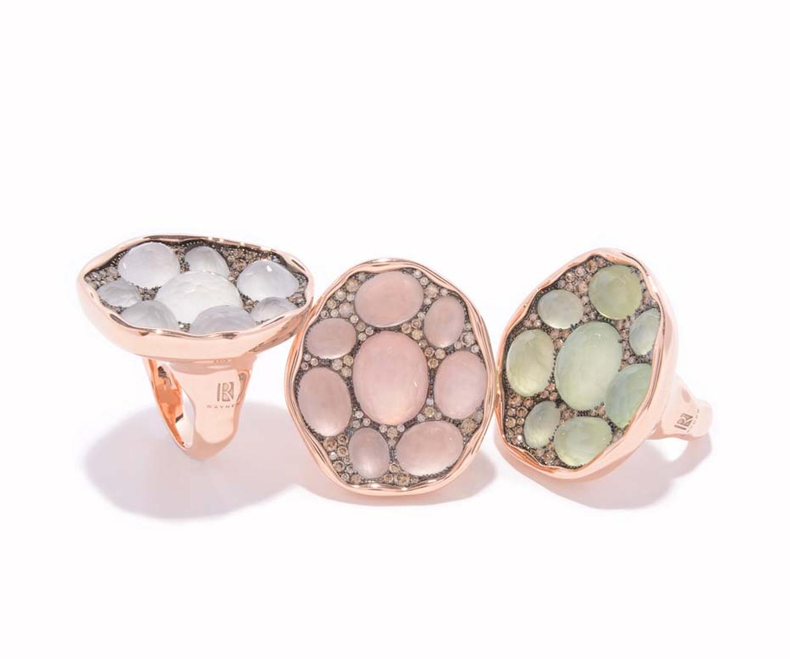 Rodney Rayner red gold rings featuring, from left to right, 8 white quartz, 8 rose quartz and 8 prehnites surrounded by a sprinkling of diamonds.