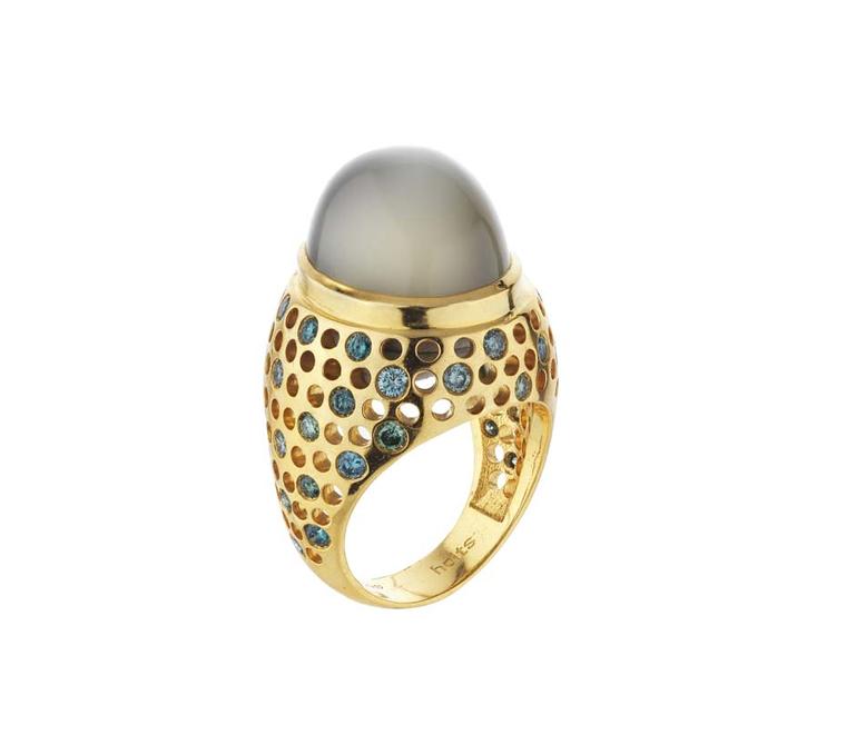 Holts Vicious moonstone ring featuring a yellow gold band studded with blue and green diamonds.