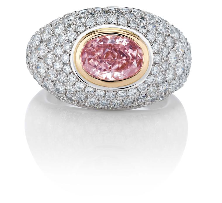 De Beers 1888 Creative Solitaires Aurora ring, with an oval Fancy Intense pink diamond surrounded by a pavé of round brilliant diamonds.