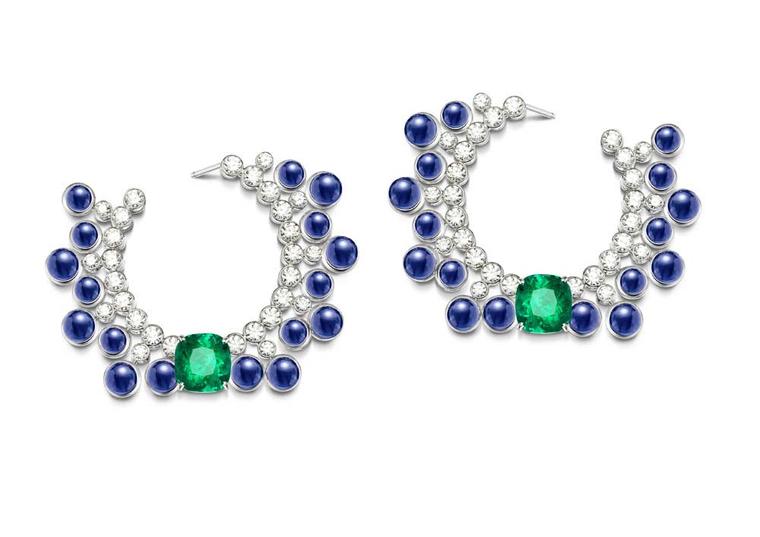 Extremely Piaget collection earrings in white gold set with 34 cabochon-cut blue sapphires, two cushion-cut emeralds and brilliant-cut diamonds.