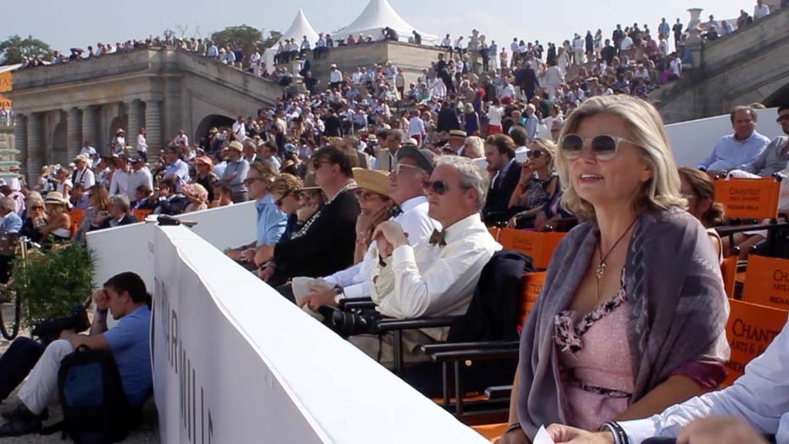 Maria Doulton sits in the stands as she enjoys automobile history unfold before her at Chantilly Arts & Elegance.