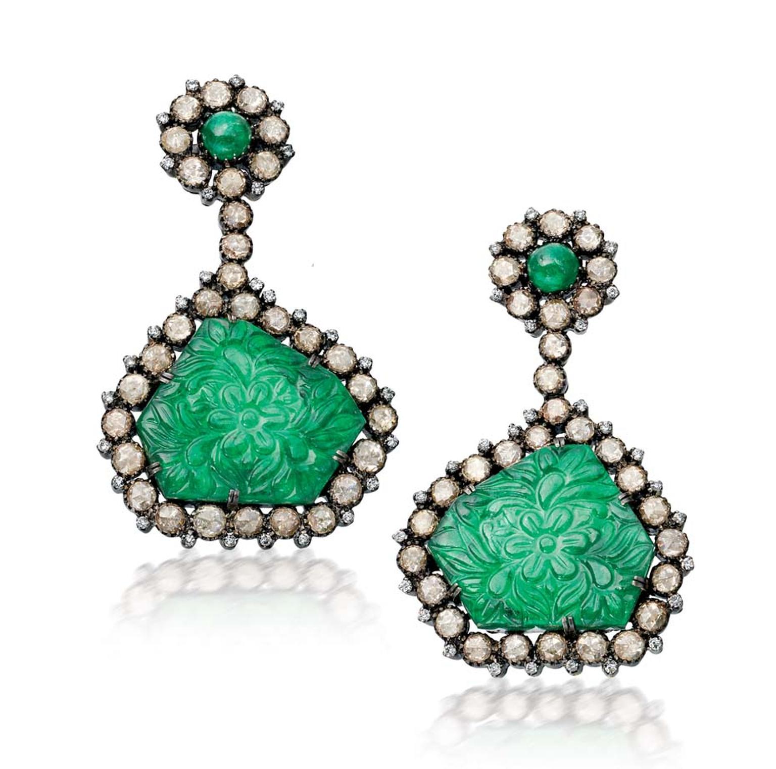 Amrapali Emerald earrings with floral carvings surrounded by diamonds.