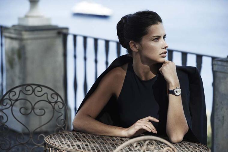 Adriana Lima looks to the Portofino seaside while wearing the IWC Schaffhausen Portofino Midsize Automatic Moon Phase watch with an alligator leather strap.