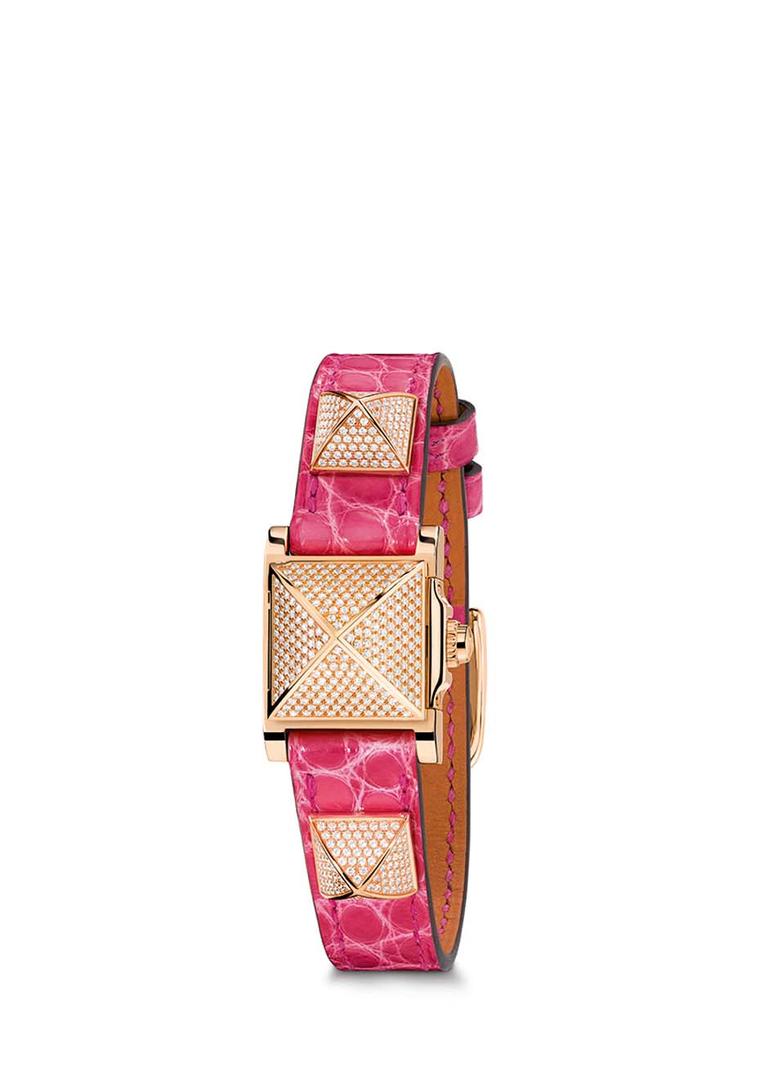 Hermès Médor watch with a pink leather bracelet with three pronounced rose gold pyramid studs set with pavé diamonds.