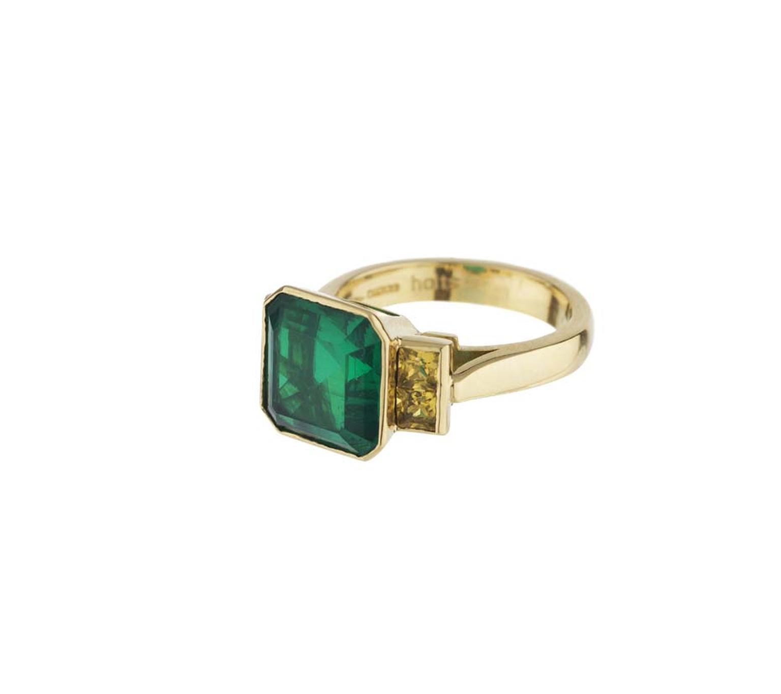 Holts London collection yellow gold Strand ring featuring a doublet centre emerald with yellow sapphire set shoulders.