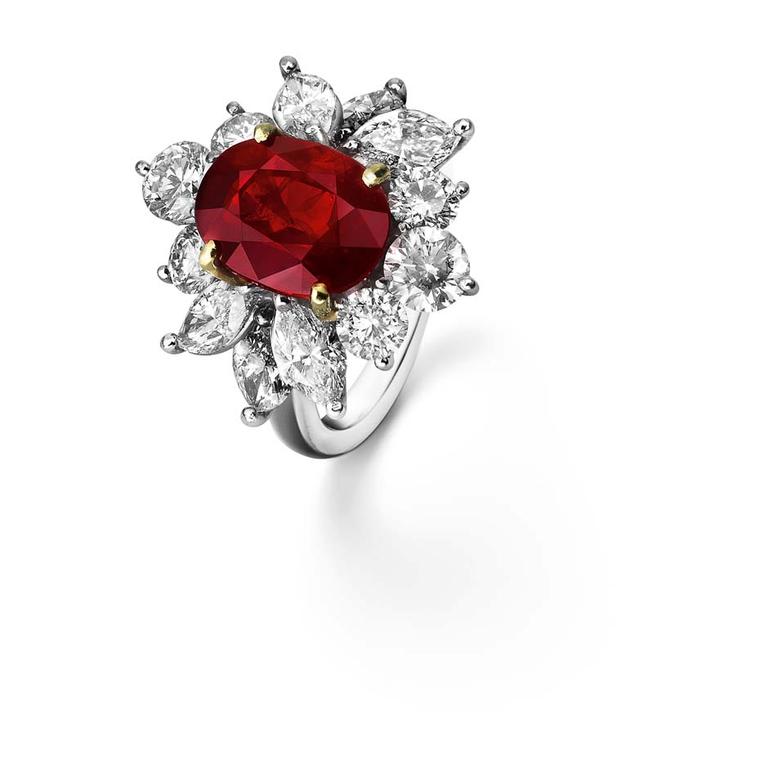 Asprey ruby engagement ring in platinum framed with triangular diamond shoulders.