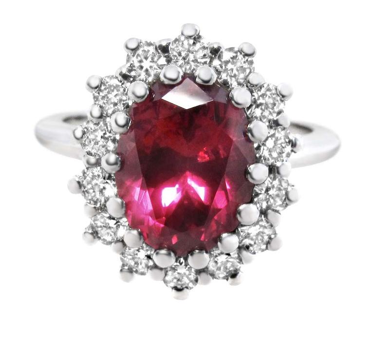 Ingle & Rhode Cluster ruby engagement ring featuring an untreated oval-shaped Malawi ruby surrounded by brilliant-cut diamonds.