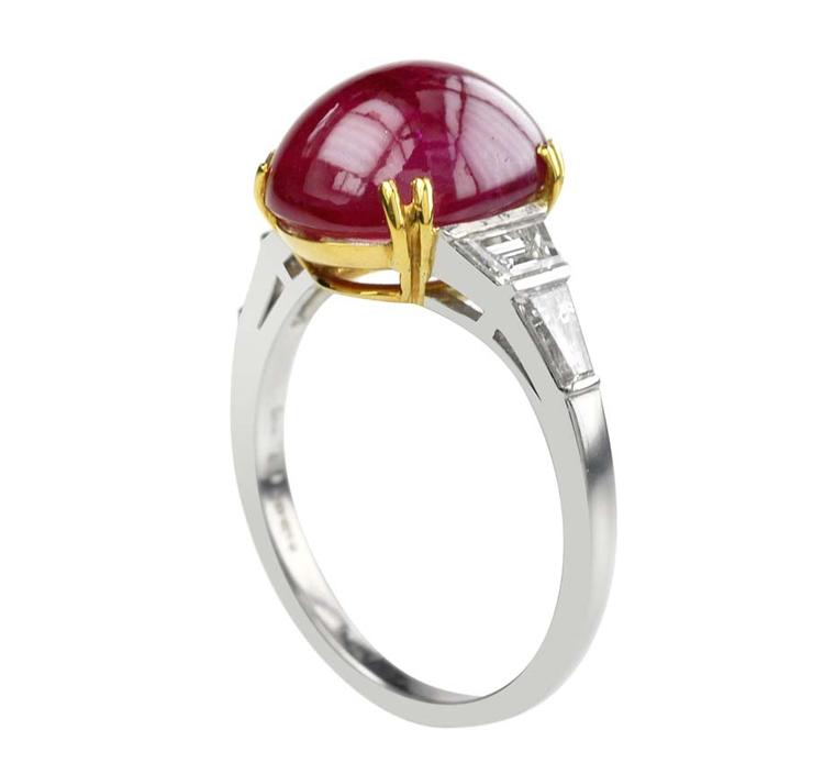 Lucie Campbell ruby engagement ring with a cabochon ruby set in yellow gold and a diamond band set in platinum and white gold.