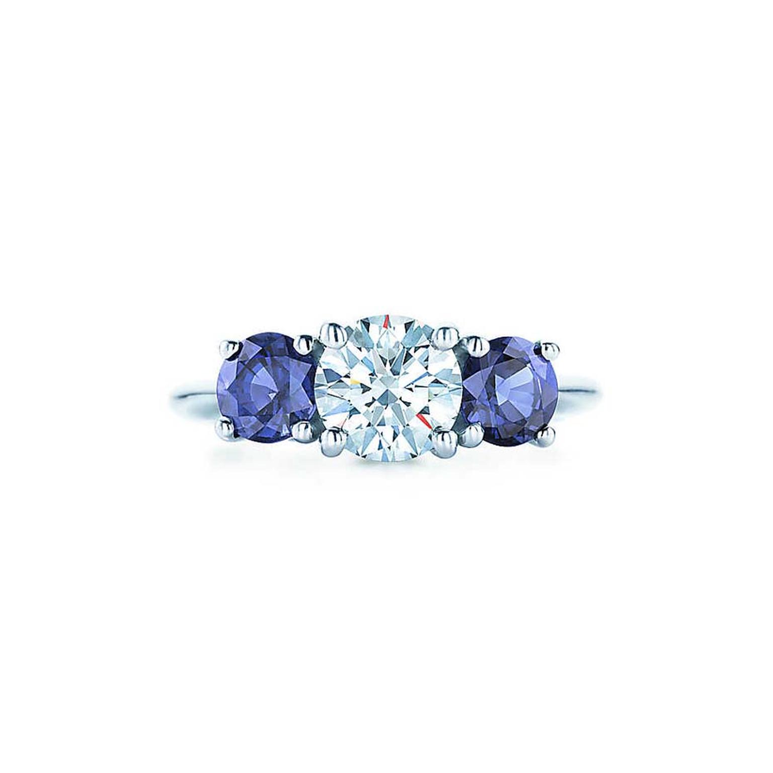 Tiffany & Co. ring featuring a central brilliant-cut diamond flanked by a sapphire on either side.