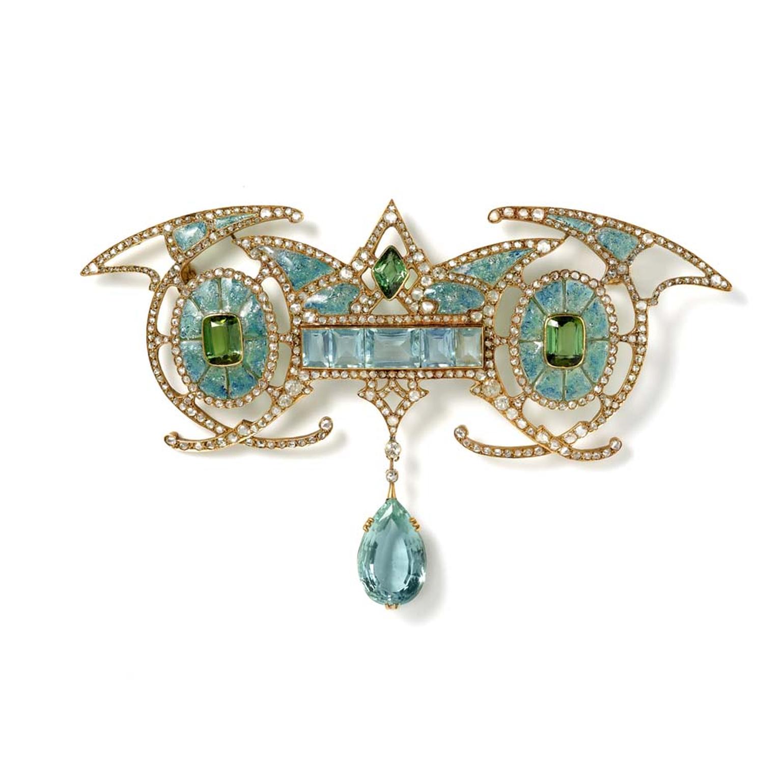 Art Nouveau yellow gold brooch designed with a central aquamarine panel carrying an aquamarine drop in between two green tourmalines within enamelled ovals with diamonds, by Georges Fouquet, Paris. Exhibited by Hancocks.