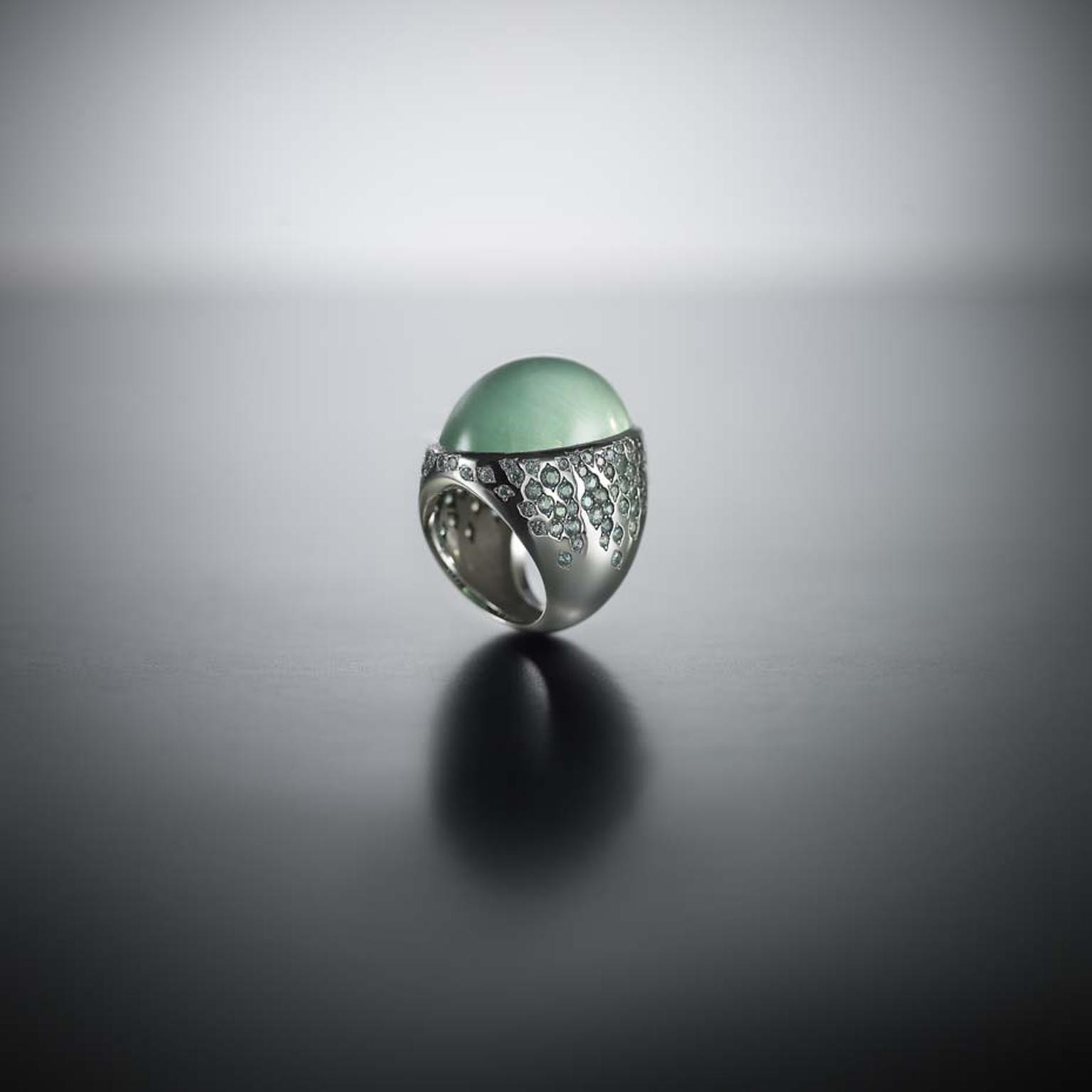 Walid Akkad cabochon green beryl ring with streams of green-grey sapphires and diamonds set on the shoulders.