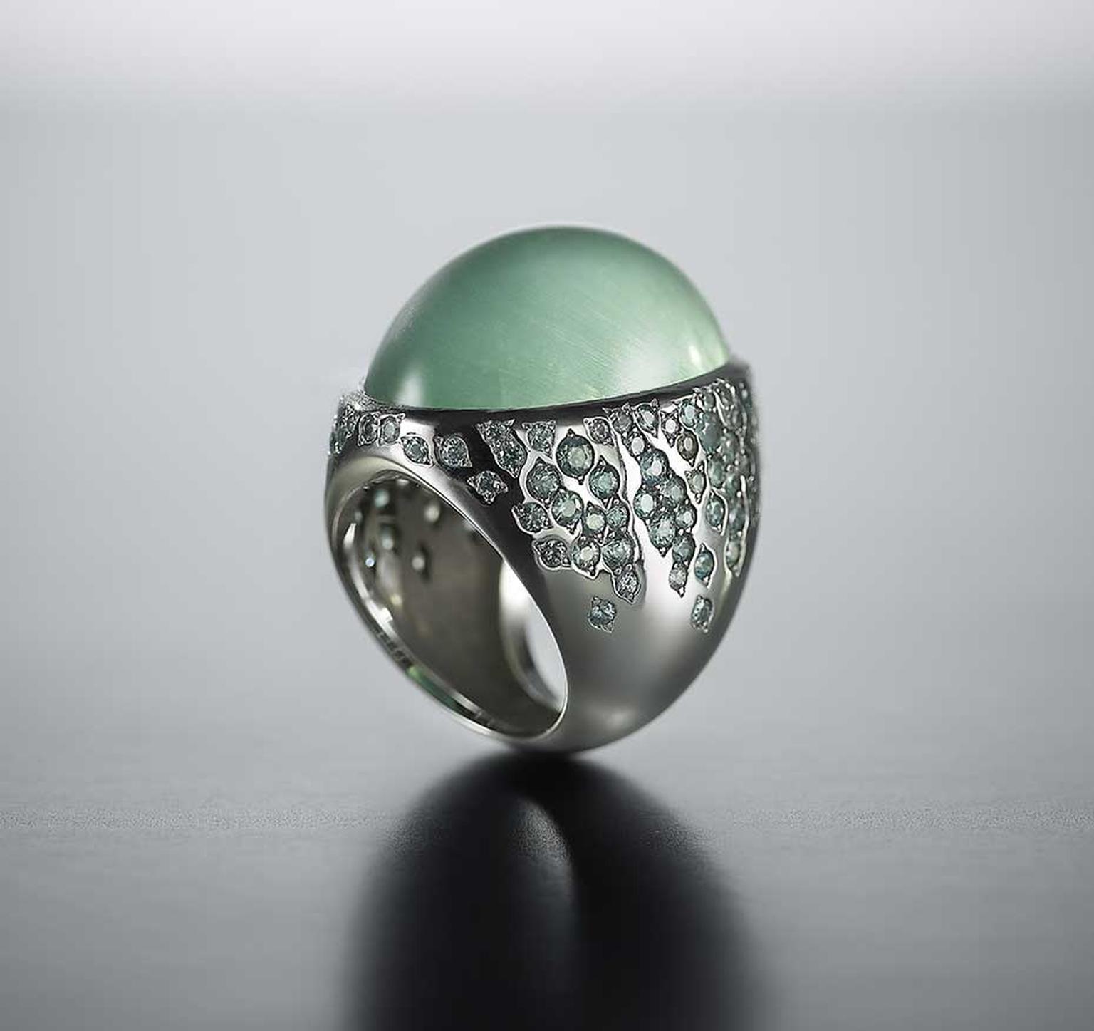 Walid Akkad cabochon green beryl ring with streams of green-grey sapphires and diamonds set on the shoulders.