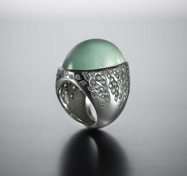 Walid Akkad cabochon green beryl ring with streams of green-grey sapphires and diamonds set on the shoulders.