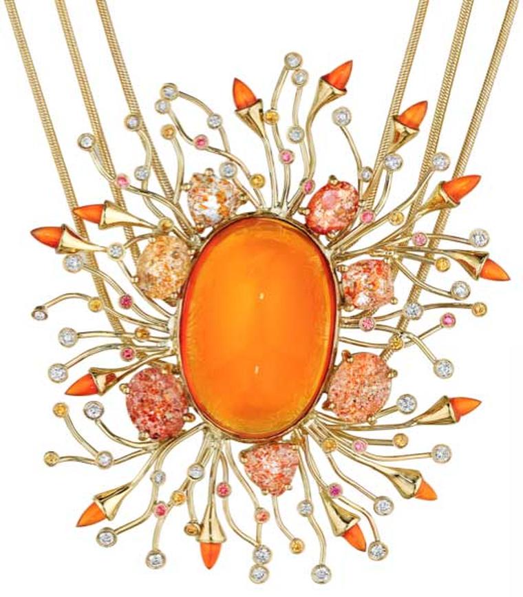 One-of-a-kind Madstone Apollo pendant with fire opal arrows moving like tadpoles in every direction around a stunning oval fire opal.
