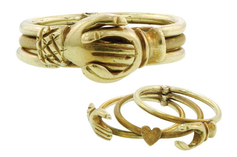 Gold Fede Gimmel ring featuring three movable attached rings that, when closed, shows two hands clasped and when opened displays a heart.