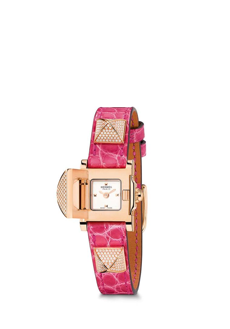 With a pink leather bracelet with three pronounced rose gold pyramid studs set with pavé diamonds, the largest pyramid in the centre of the Hermès Médor watch opens to reveal the opaline silvered dial of the watch that keeps impeccable time thanks to a Sw