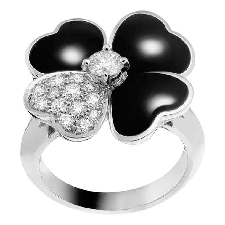 Van Cleef & Arpels Cosmos ring in white gold with a brilliant-cut diamond bud surrounded by onyx and diamond petals.