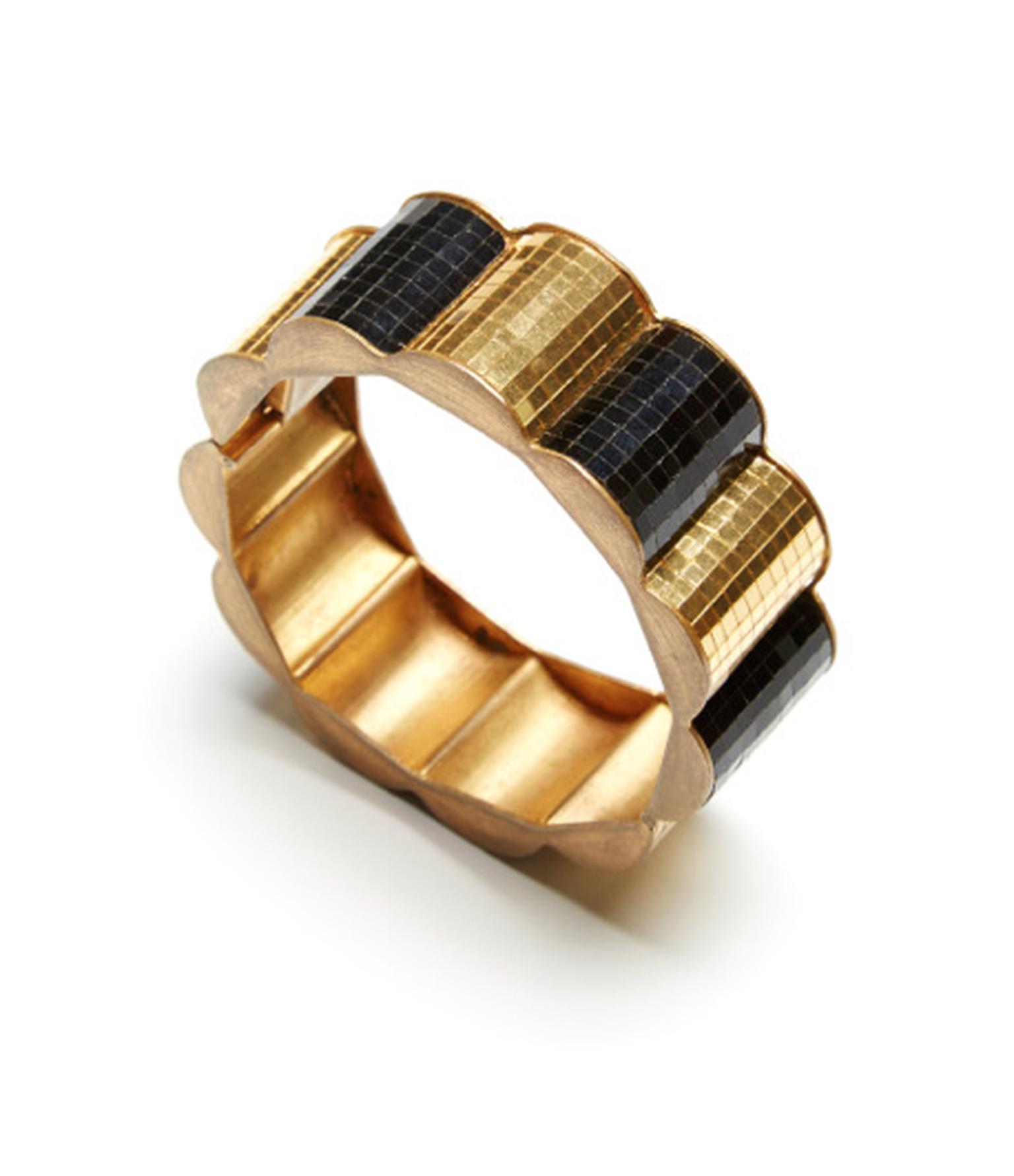 FD Gallery's Boivin yellow gold bangle circa 1935, featuring a hidden lock closure and black scallop detailing. $78,571 at Moda Operandi.