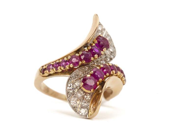 Boucheron circa 1945 yellow gold and platinum stylised crossover ring set with mixed-cut rubies and single-cut diamonds.