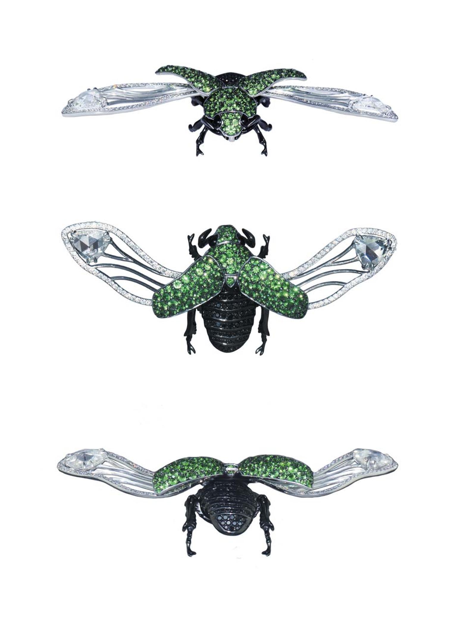 A white gold and black rhodium-plated Beetle brooch set with round black diamonds and tsavorites.