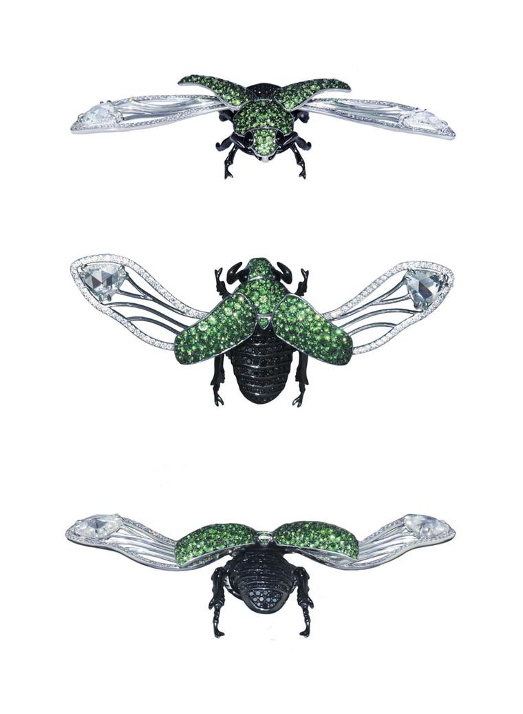 A white gold and black rhodium-plated Beetle brooch set with round black diamonds and tsavorites.