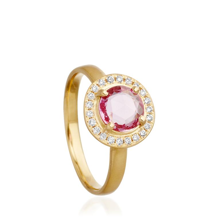 Anne Sportun sapphire engagement ring from Astley Clarke with a pink sapphire centre stone set in gold and surrounded by a circle of channel-set white diamonds (£2,700).