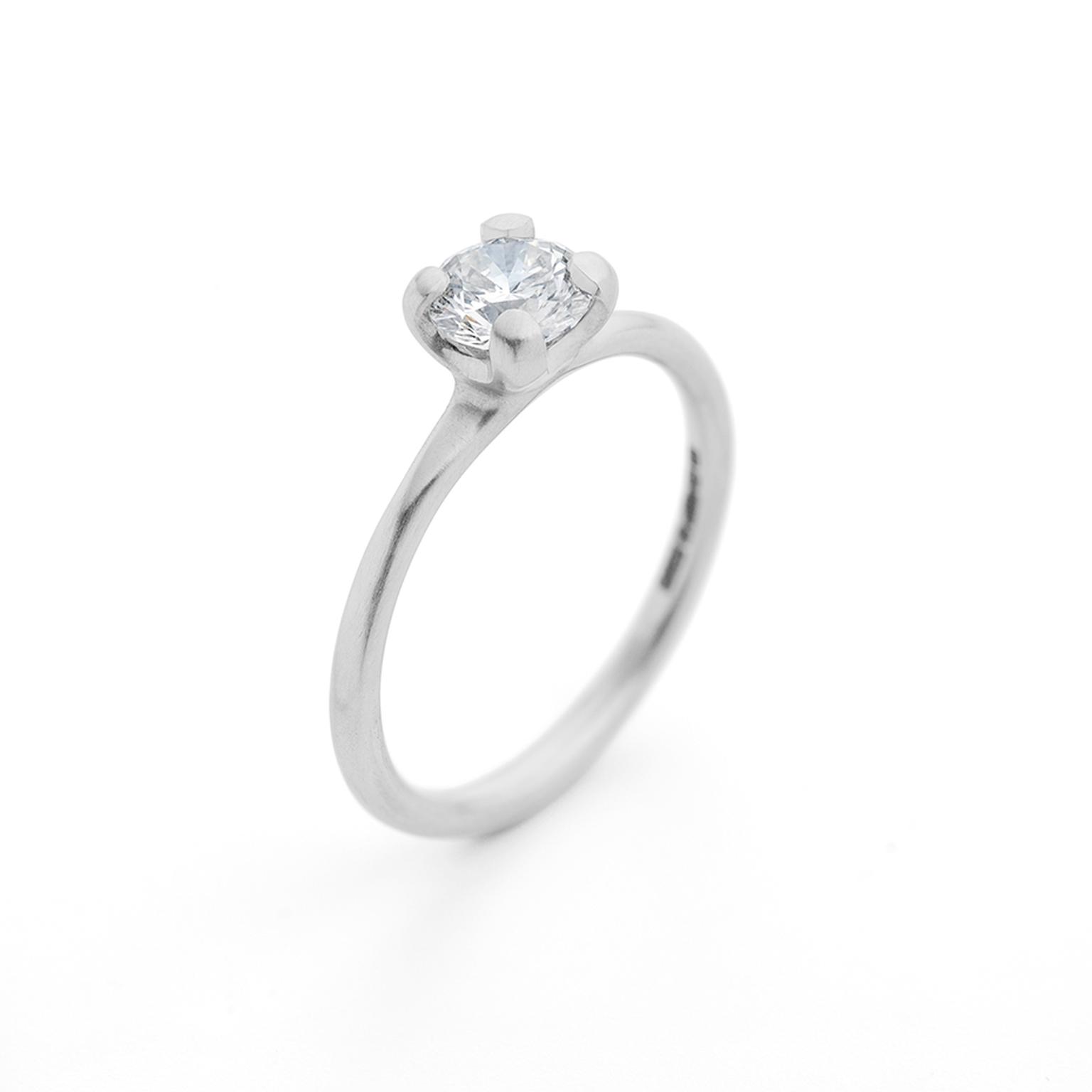 McCaul four claw platinum and diamond engagement ring with a centre brilliant-cut diamond.