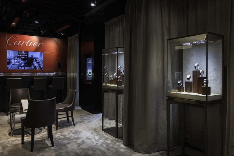 The Fine Watch Bar at The Man by Cartier pop-up salon in Harrods has the feeling of a gentleman's club with its comfortable chairs and dark wood paneling.