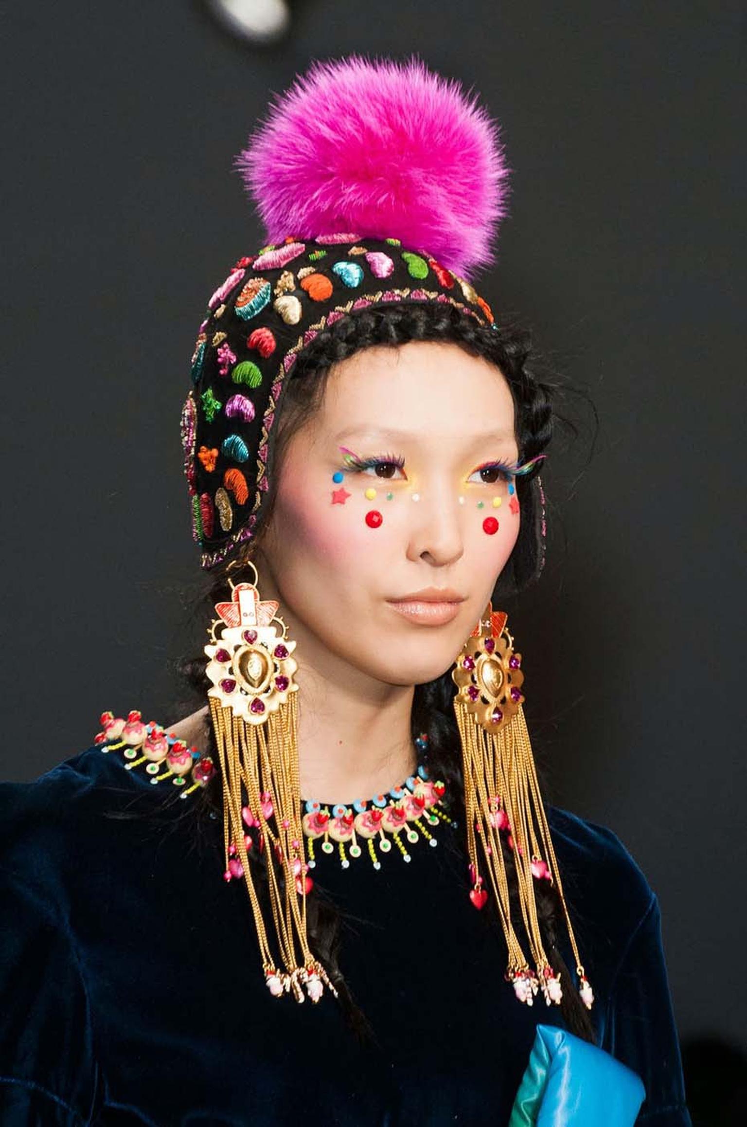 A model showcasing earrings from the Amrapali and Manish Arora AW 2014-15 collection during Paris Fashion Week.