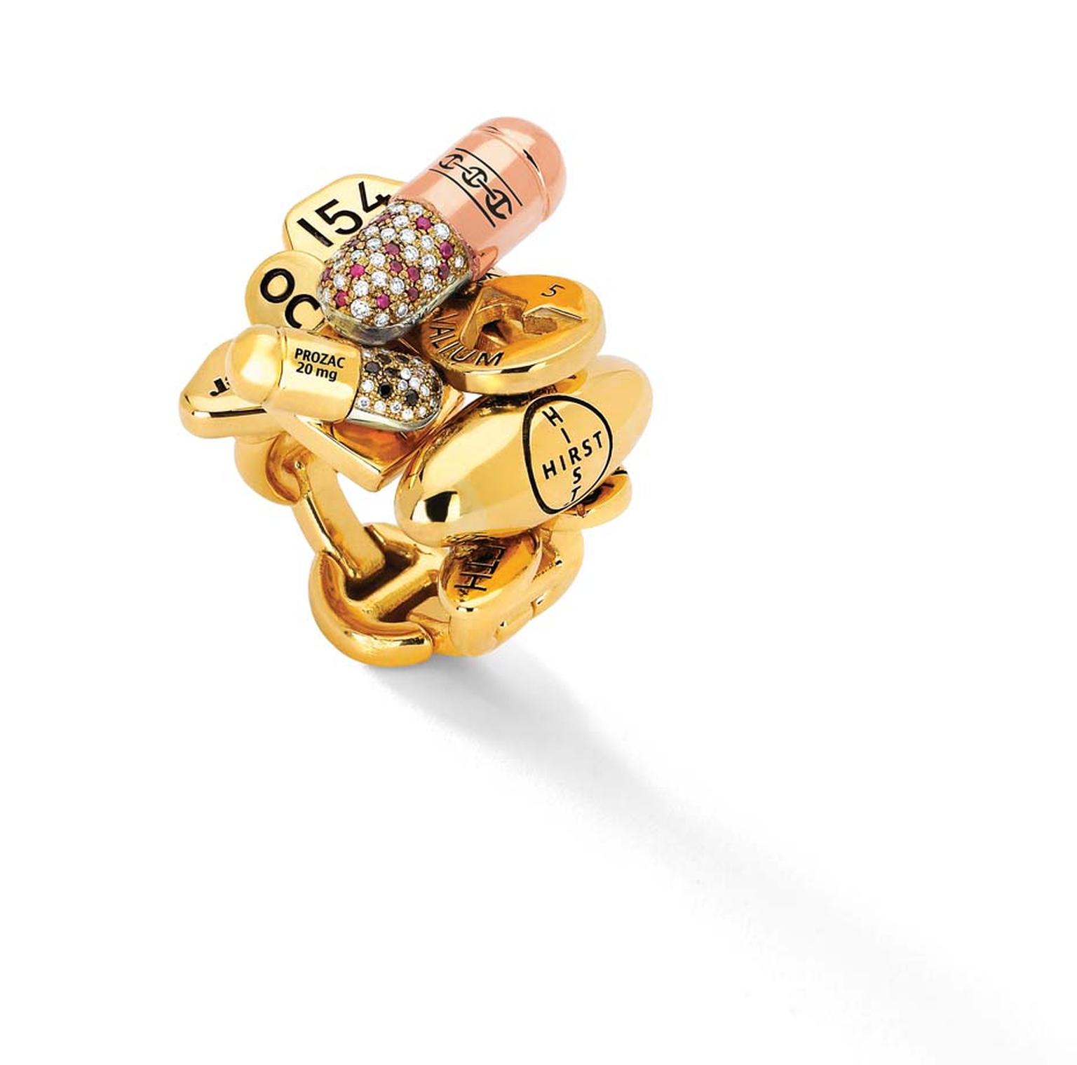 Hoorsenbuhs limited-edition Pill ring, created in collaboration with British artist Damien Hirst, colorfully mixes rose, yellow and white gold with rubies and black and white diamonds with the brand's signature links.
