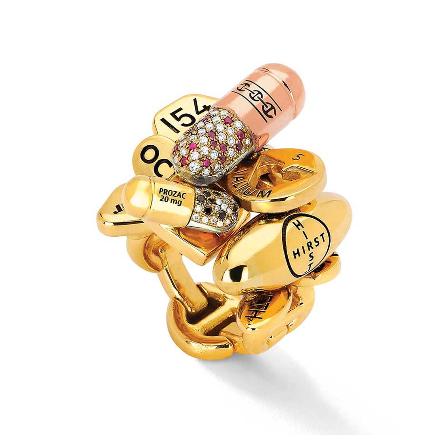 Hoorsenbuhs limited-edition Pill ring, created in collaboration with British artist Damien Hirst, colorfully mixes rose, yellow and white gold with rubies and black and white diamonds with the brand's signature links.