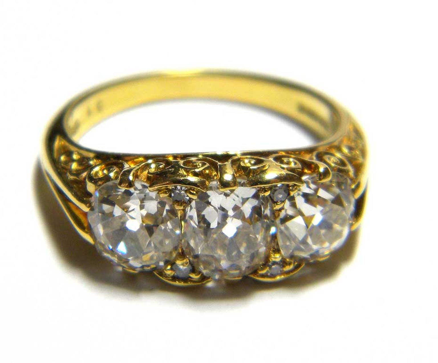 Three stone old-cut diamond engagement ring inyellow gold