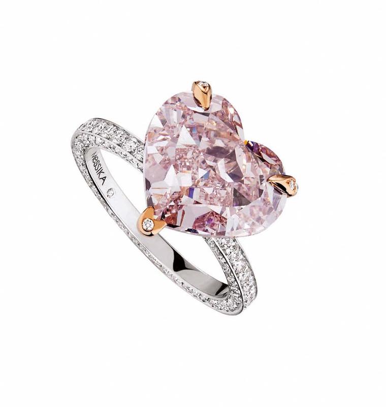 Messika heart-shaped pink diamond engagement ring set with rose gold prongs and a pavé diamond band.