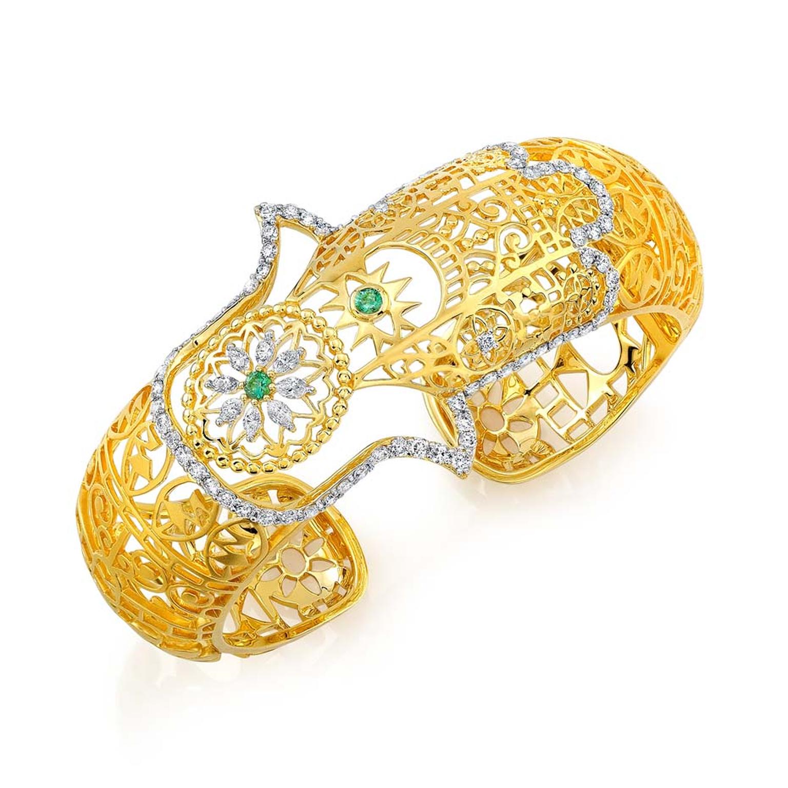 Buddha Mama filigree hinged Hamsa cuff with diamonds and emeralds ($18,400).