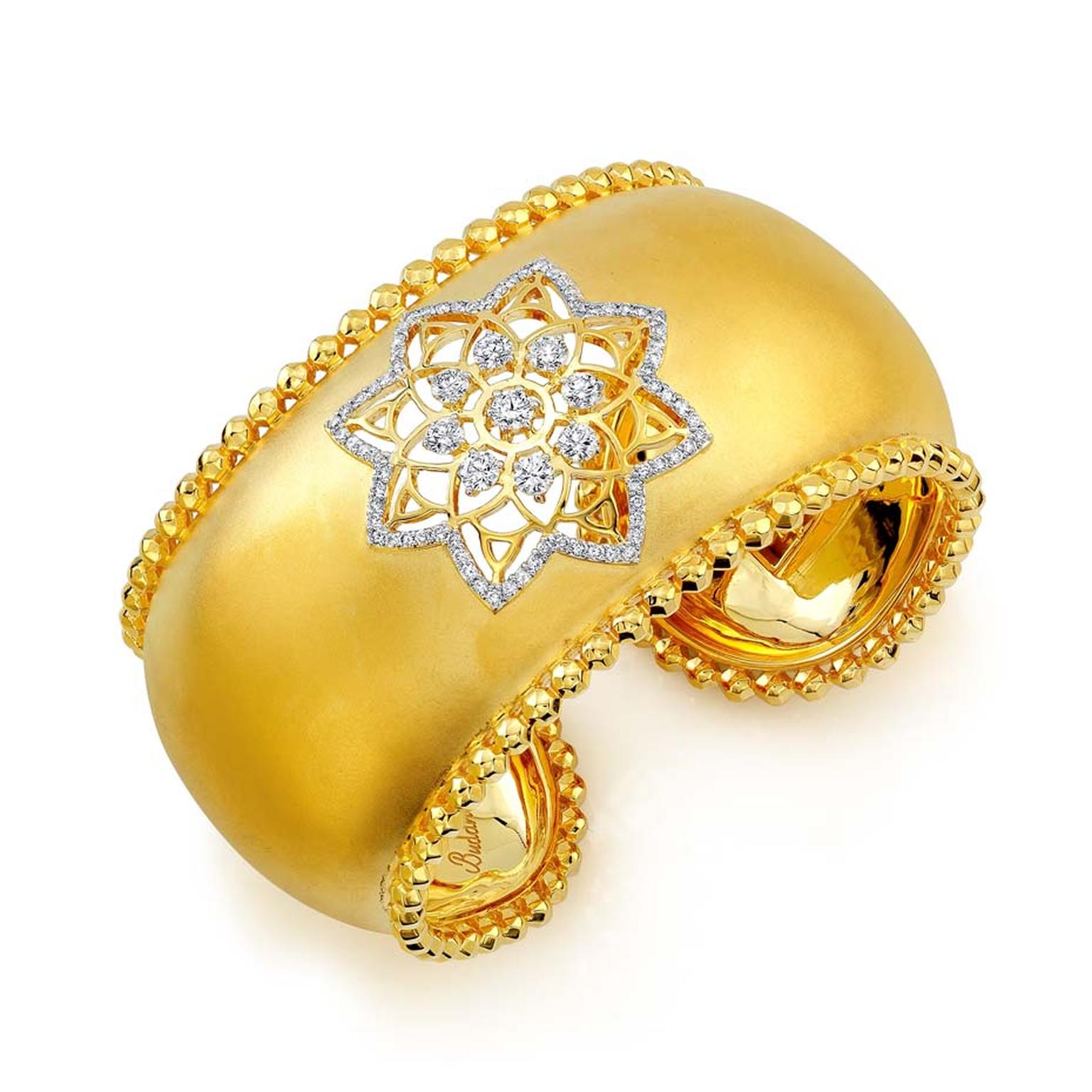 Buddha Mama Dharma Wheel cuff with a cut-out diamond mandala and hollow spheres around the borders ($28,400).