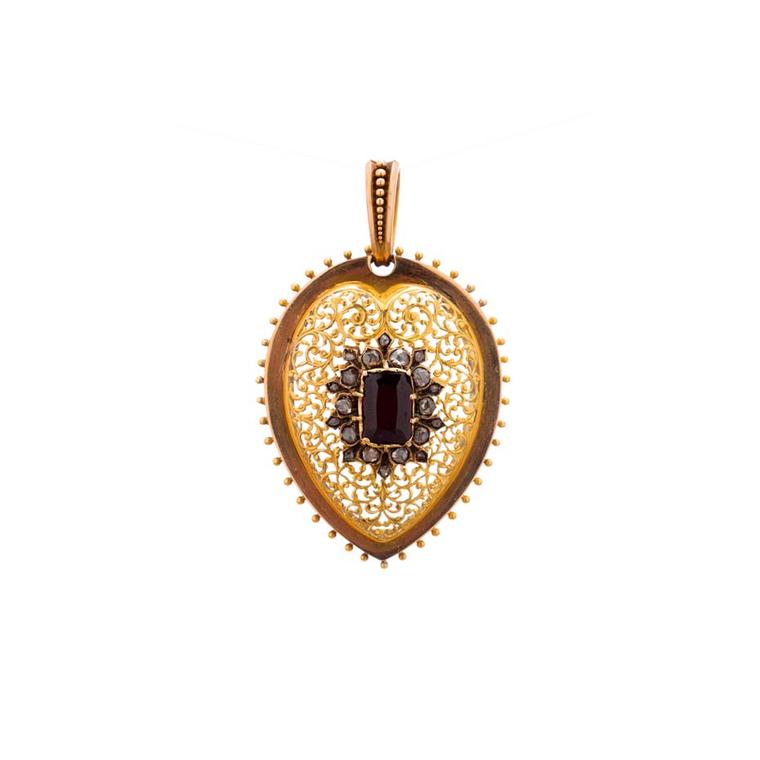Broken English vintage heart locket in yellow gold  with a center garnet and white diamonds ($6,400).