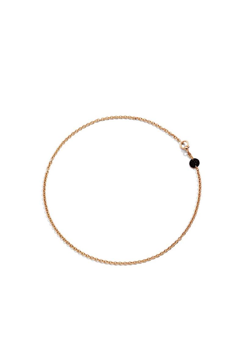 Pomellato Sabbia choker necklace featuring a rose gold disc with black diamonds.