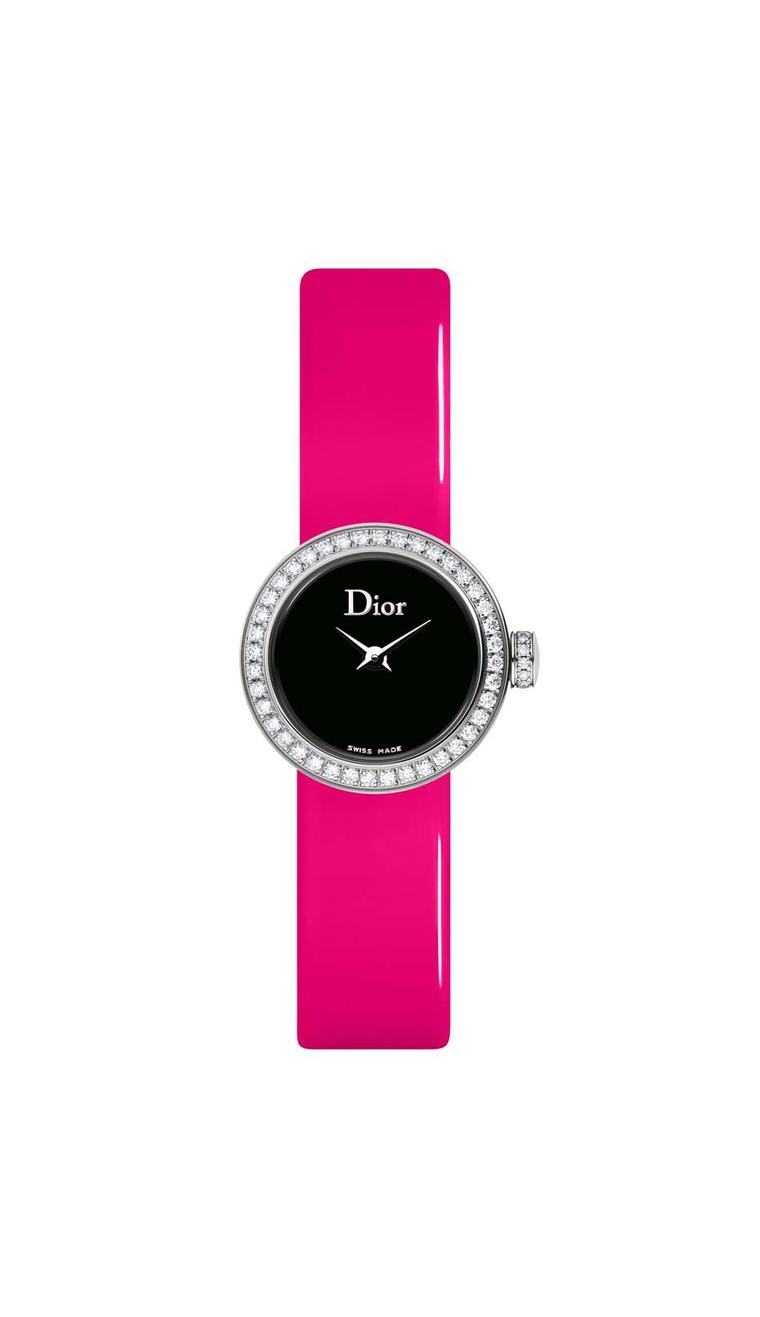 La Mini D de Dior watch with an inky black mother-of-pearl dial set alight with diamonds on the bezel and crown and a fluoro pink strap (£2,900).