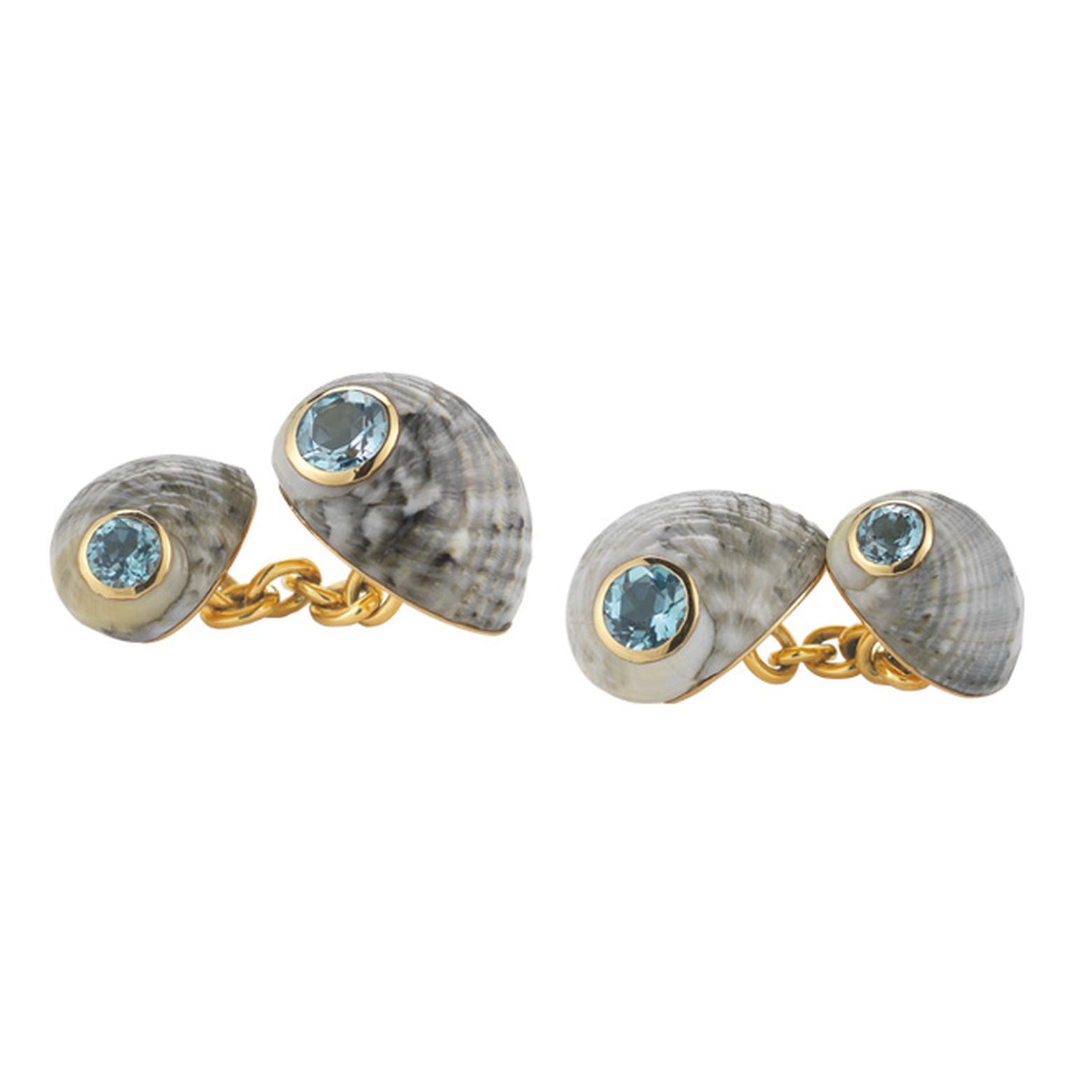 Trianon yellow gold chain-link cufflinks featuring one large and one small blue grey Nerita Chameleon shell that sit on either side of the cuff. The shells are decorated with faceted round-cut aqua blue topaz ($3,600).