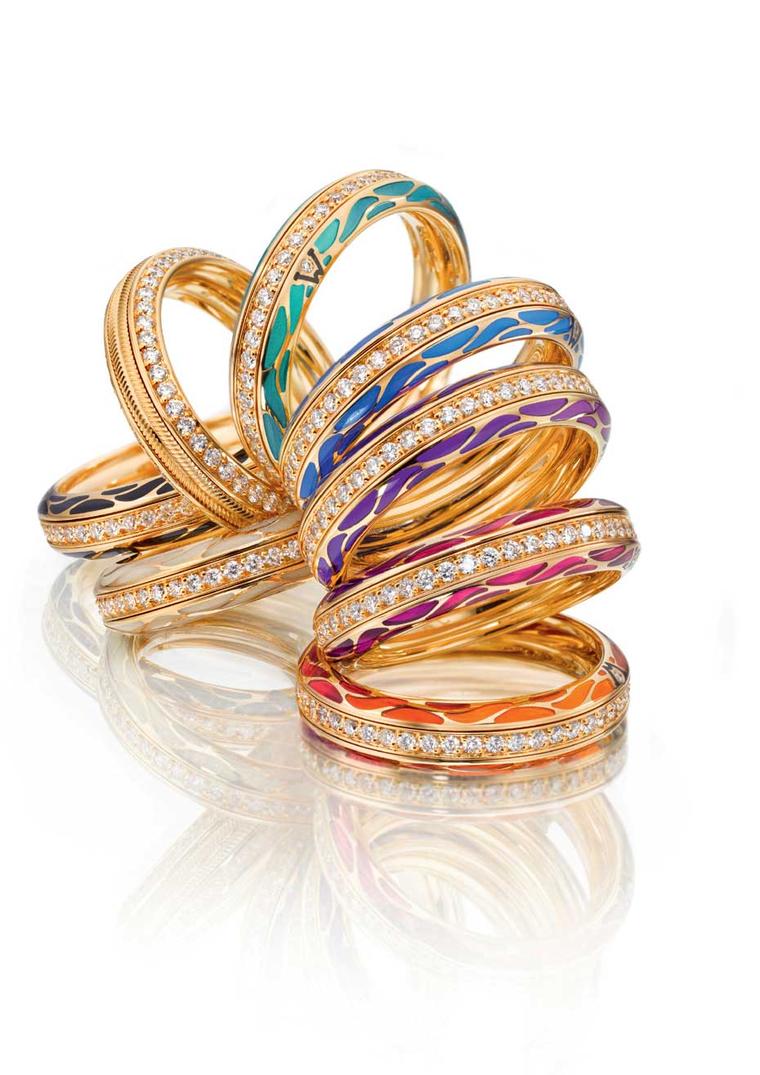 Wellendorff Genuine Delight gold rings with diamonds and coloured enamel. Each ring is comprised of three individual rings that link together to allow them to spin freely.