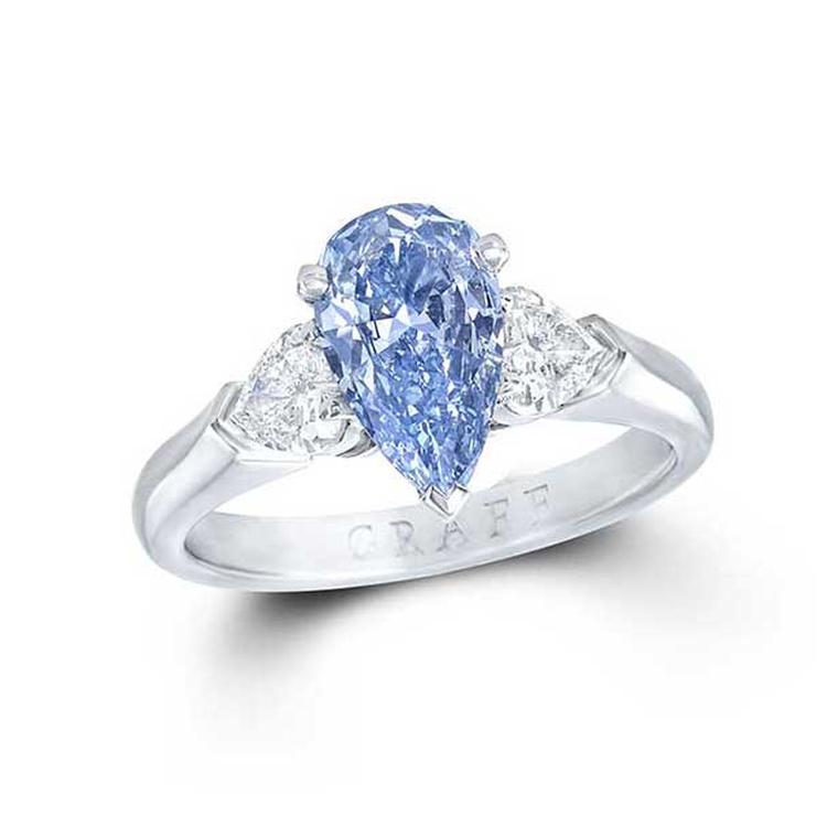 Graff 1.04ct Internally Flawless blue diamond engagement ring flanked by two pear-shaped white diamonds.