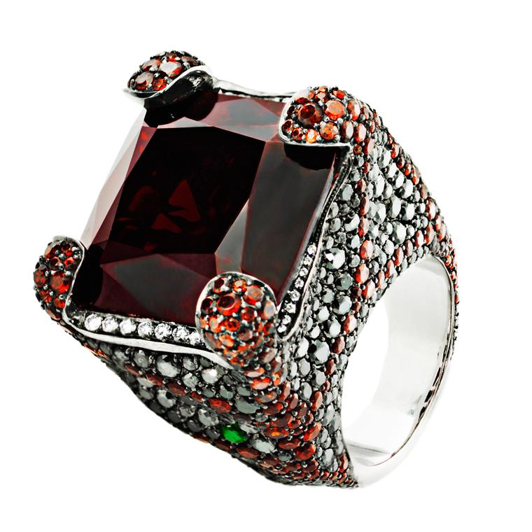 Crow's Nest ring set with white and black diamonds, a central red garnet and a pear-shaped tsavorite, from the Deluxe Russian Grooves collection.