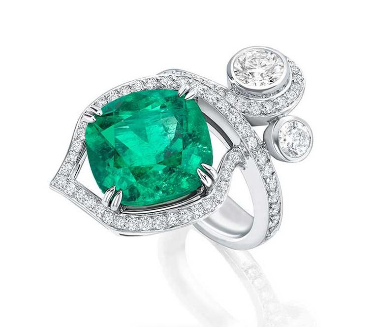 Boodles Greenfire emerald ring, set with a single emerald surrounded by pavé diamonds and two brilliant-cut diamonds designed to look like entwined forest foliage.