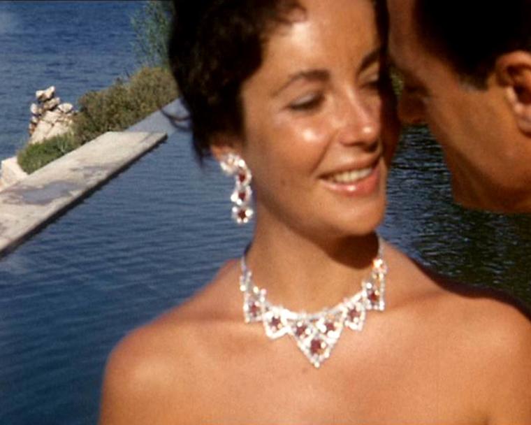 Elizabeth Taylor in 1957 wearing the Cartier ruby jewellery set just given to her by Mike Todd - she later jumped into the pool, rubies and all. © Premium Archive Films/Getty Images