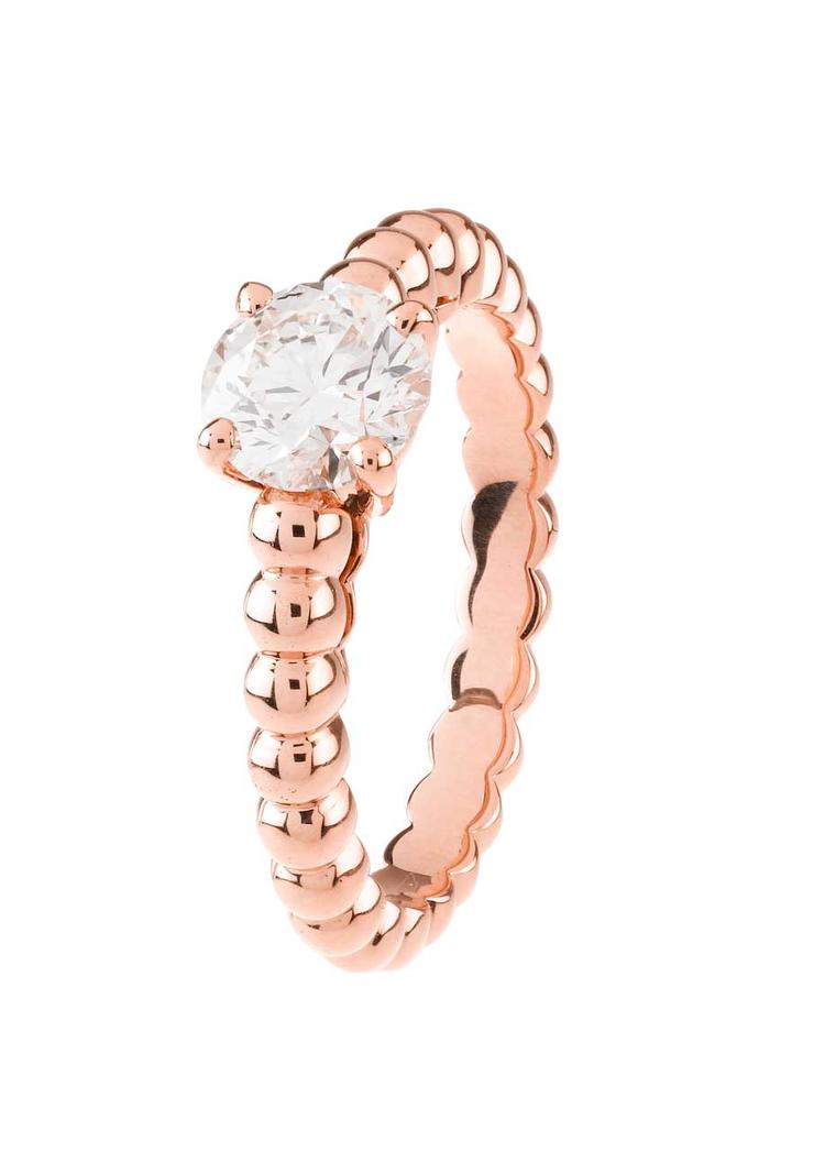 Van Cleef & Arpels' rose gold engagement ring from the Perlée Collection is set with a single diamond.